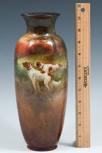 ROYAL DOULTON HUNTING DOGS POTTERY VASE: ROYAL DOULTON HUNTING DOGS POTTERY VASE: A hand painted vase with a flared rim, Depicting a naturalist setting of two spaniel-type dogs on the hunt at the edge of the woods. Black back stamp at the un