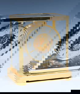 SWISS LECOULTRE ATMOS 15 JEWEL CLOCK: SWISS LECOULTRE ATMOS 15 JEWEL CLOCK: A 1960's glass encased perpetual motion Atmos clock within gilt brass frame, by Jaeger-LeCoultre. 15 jewels, Swiss-made with a round dial, serial #162751. Approx.