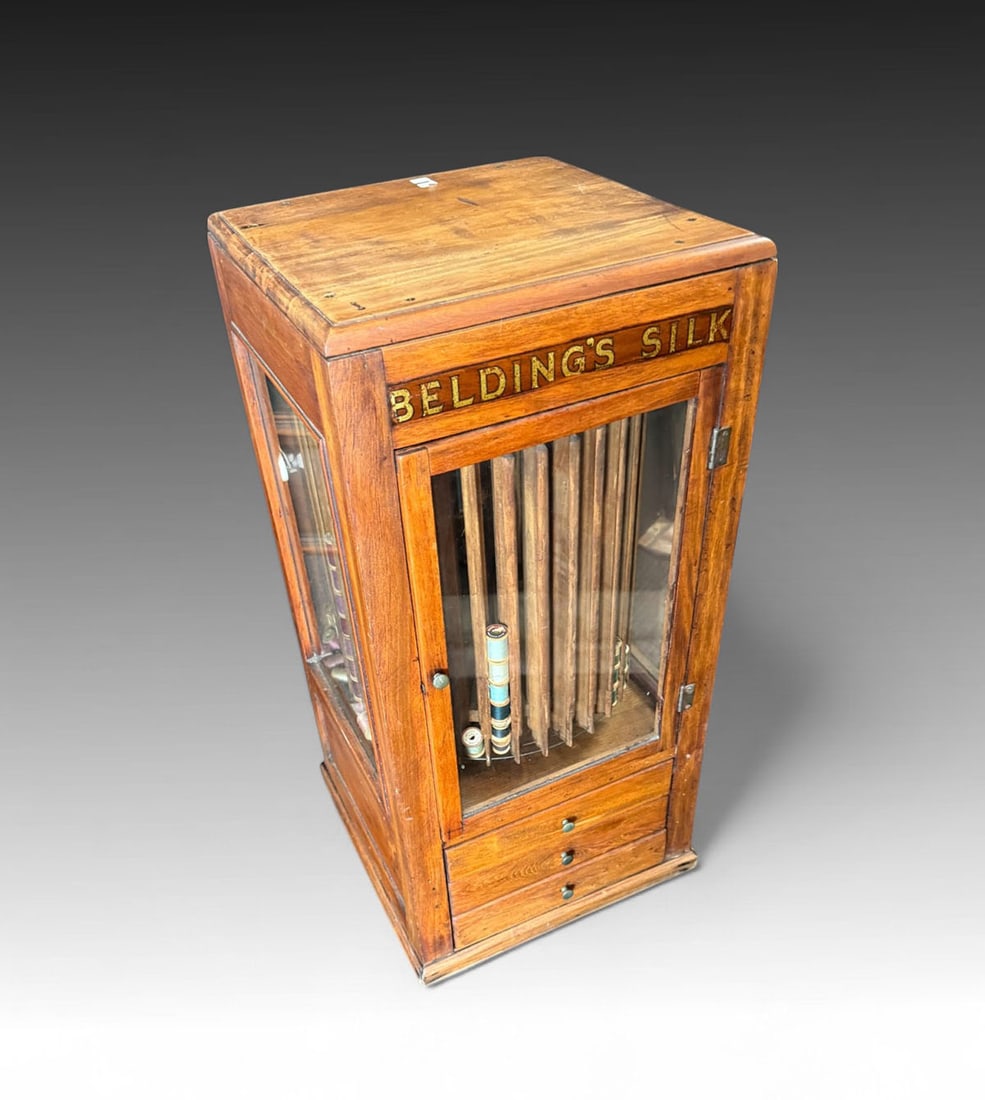 BELTING'S SILK REVOLVING STORE DISPLAY CABINET: BELTING'S SILK REVOLVING STORE DISPLAY CABINET: Late 19th Century cabinet with Revolving Spool Display containing a variety of spools in a spectrum of colors. All over three fitted drawers. Single lig