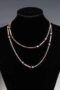 18K PLATINUM DIAMOND LONG CHAIN: 18K PLATINUM DIAMOND LONG CHAIN: Sleek 18K yellow gold and platinum diamond necklace containing 15 round brilliant cut and old European round cut diamonds and 7 18K yellow gold batons. .75" in length.