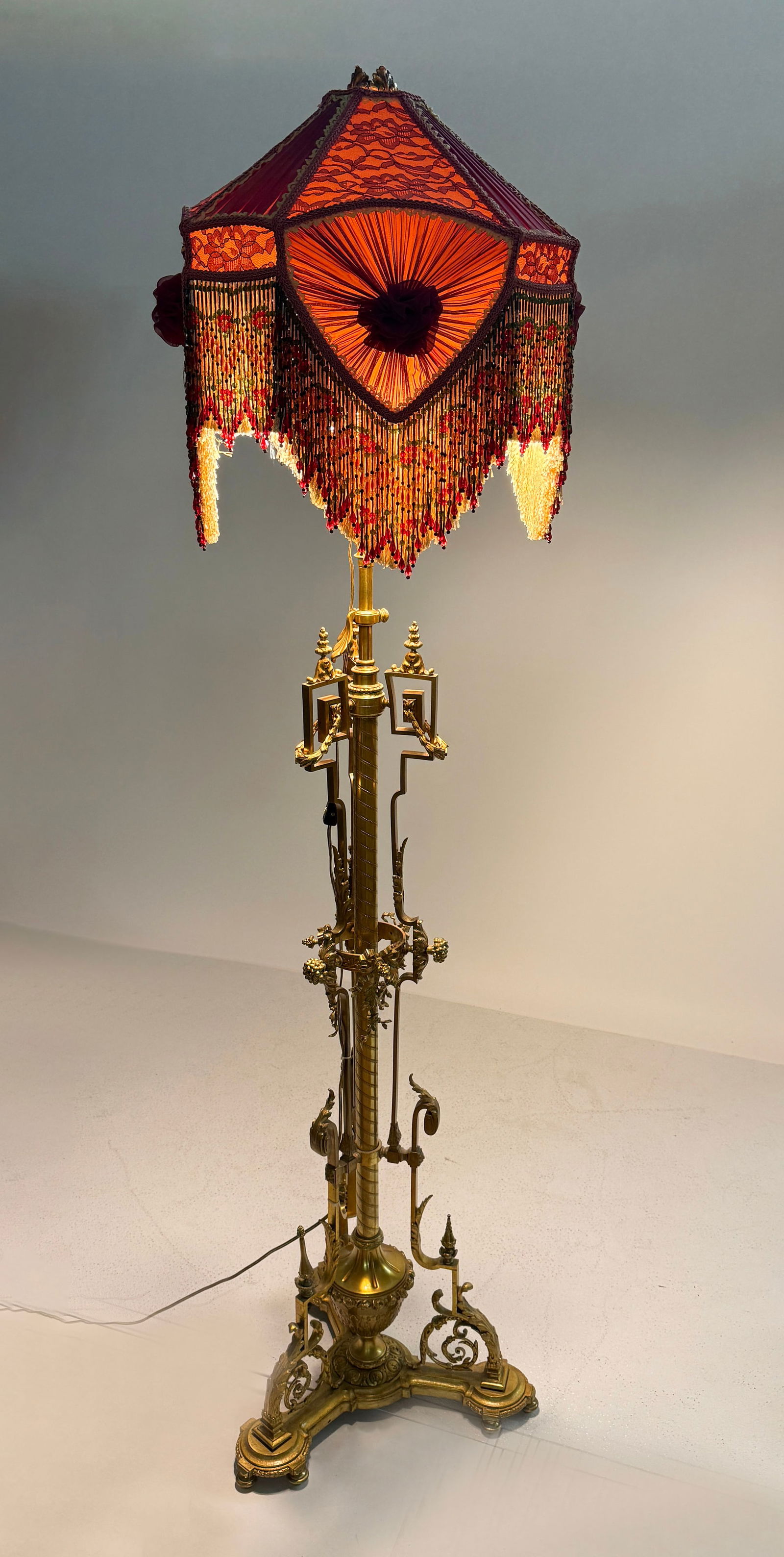 NEOCLASSICAL GILT BRONZE BOUDOIR FLOOR LAMP: NEOCLASSICAL GILT BRONZE BOUDOIR FLOOR LAMP: Gilt Bronze 2- Light Neoclassical floor lamp, adorned by Berry Clusters, Acanthus leaves, Draped Foliate, & Ribbons. Surmounted by a beaded cloth shade wit