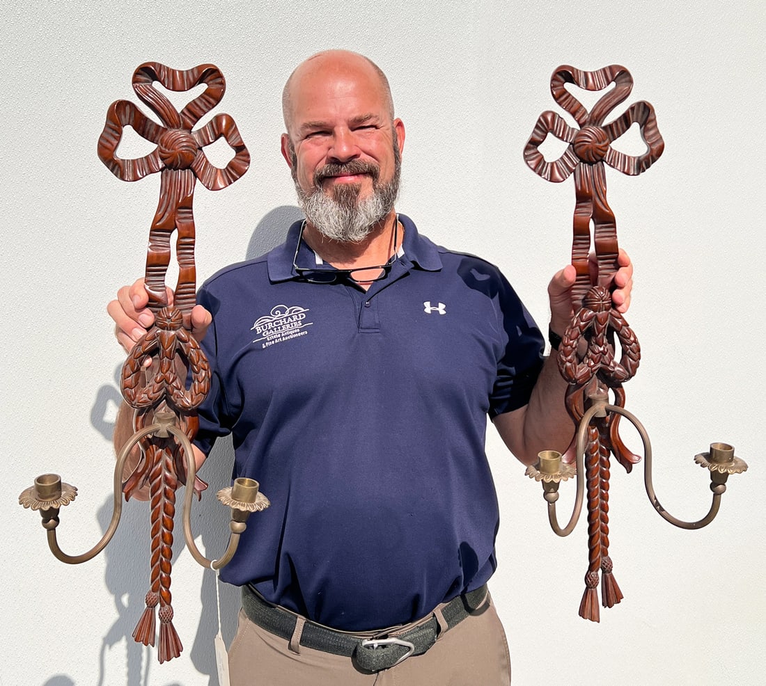 2 FRENCH CARVED WOOD SCONCES: 2 FRENCH CARVED WOOD SCONCES: Pair of carved Mahogany French 2- Light wall sconces, having a Ribbon and Rope Twist body, with scrolled brass arms, terminating in Tassels. 29.5" h x 10.5" w x 7.5" d.