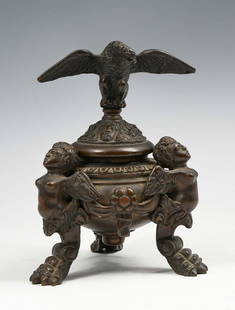 BRONZE NAPOLEON III INKWELL W/ EAGLE & ANGELS: BRONZE NAPOLEON III INKWELL W/ EAGLE & ANGELS: Mid 19th-century Bronze Inkwell with a surmounting Eagle Lid with female Masquerons, resting upon the body with raised on Winged-Cherub legs with Paw fee