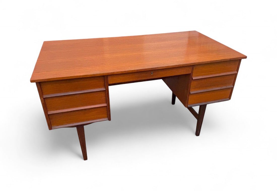 MID-CENTURY MODERN TEAK DESK WITH BOOKCASE FRONT: MID-CENTURY MODERN TEAK DESK WITH BOOKCASE FRONT: A MCM Danish Teak desk with a central drawer that opens and releases the locking mechanism which unlocks the 3- drawers to the left, and the single Fi