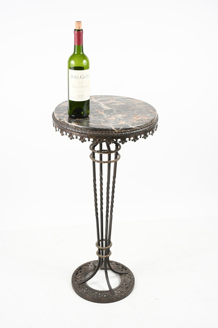 EDGAR BRANDT? MARBLE TOP WROUGHT IRON STAND: EDGAR BRANDT? MARBLE TOP WROUGHT IRON STAND: Round marble top mounted on a Twisted Wrought Iron frame with a stylized Foliate motif apron. Circular base with foliate & twisted bands. Approx. 31.25" h