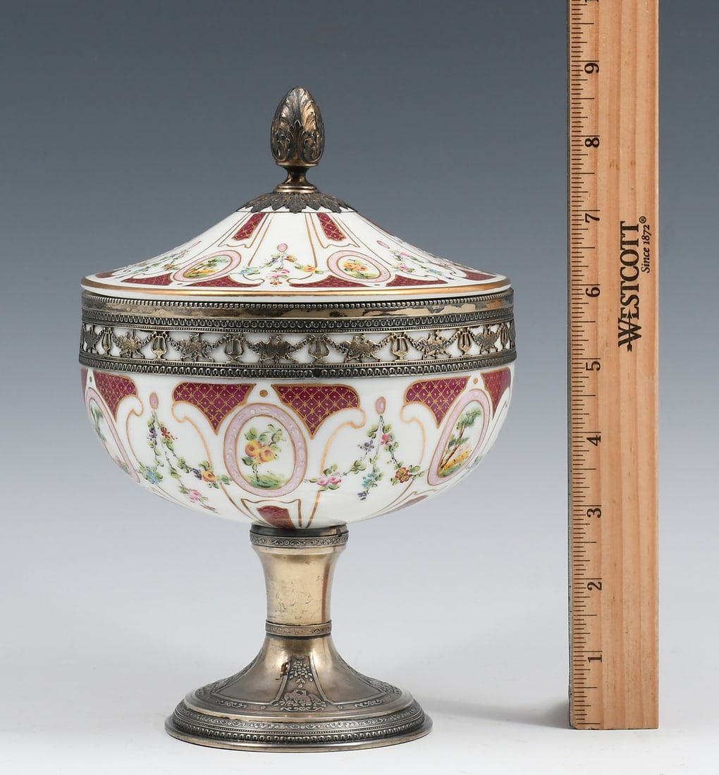 FRENCH SILVER MOUNTED SEVRES PORCELAIN COMPOTE: FRENCH SILVER MOUNTED SEVRES PORCELAIN COMPOTE: Sevres style porcelain lidded Compote, having a finely enameled Geometric & Floral motif, Silver mounted finial, rim, & foot. Underside of foot bears an