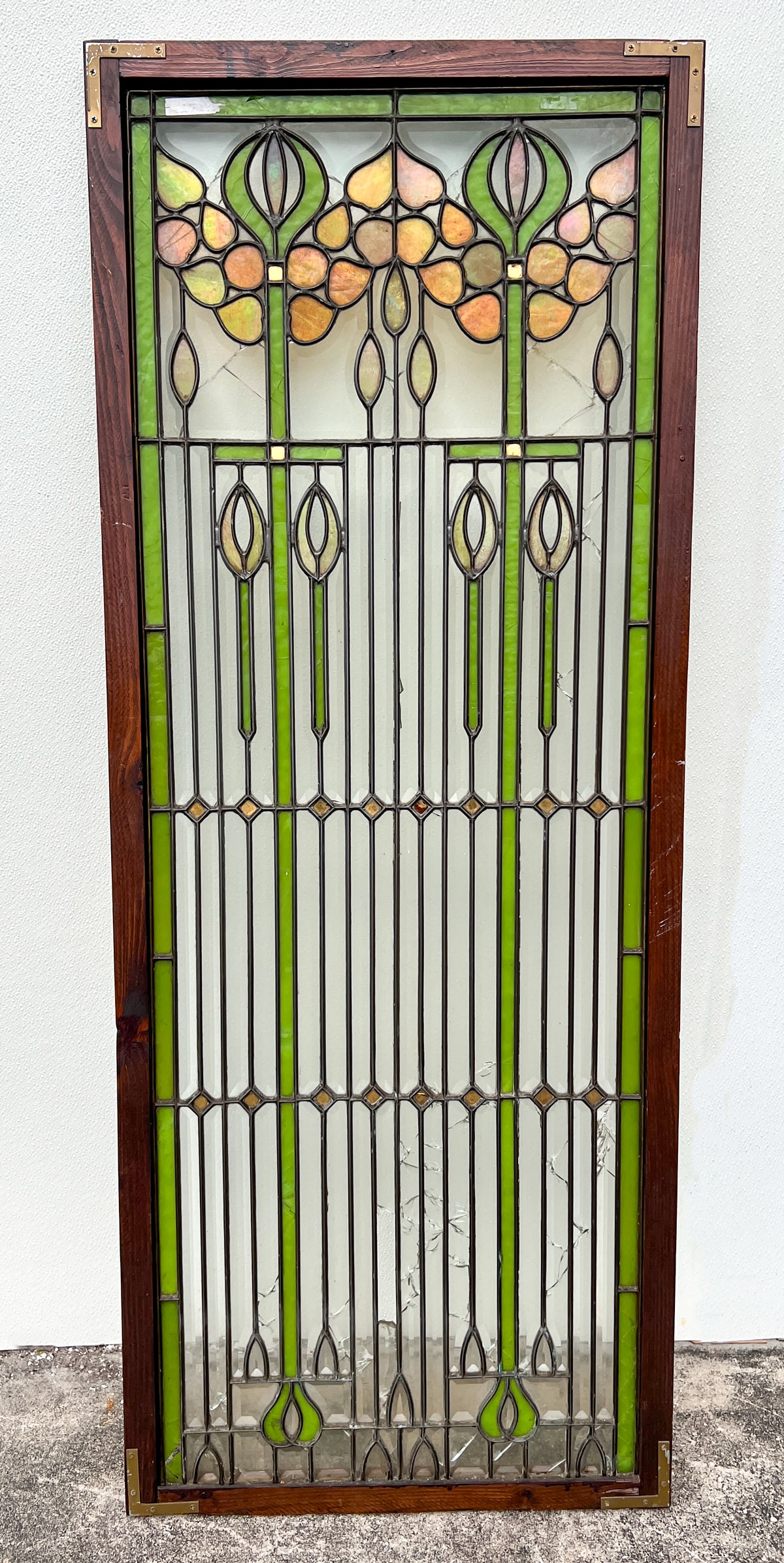 ART NOUVEAU ARCHITECTURAL STAINED GLASS WINDOW: ART NOUVEAU ARCHITECTURAL LEADED STAINED GLASS WINDOW: Oak framed Stained glass architectural window, having a Geometric design with stylized Tulips. Approx. 60.5" h x 23.625" w x 1.375" d.