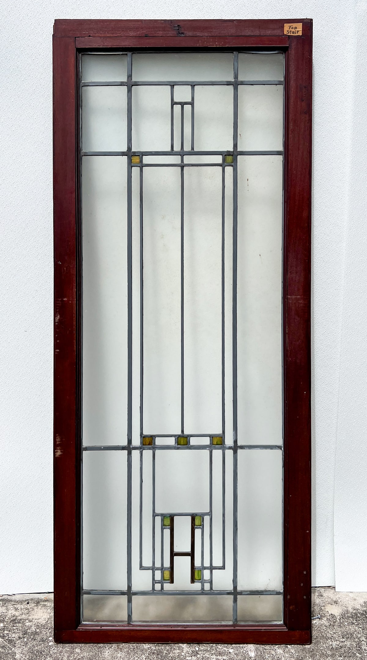 FRANK LLOYD WRIGHT INSPIRED LEADED GLASS DOOR: FRANK LLOYD WRIGHT INSPIRED LEADED STAINED GLASS DOOR: Geometric designed Leaded & Stained Glass Door with Iridescent green glass accents. Approx. 71.75" h x 29.5" w x 1.5" d.