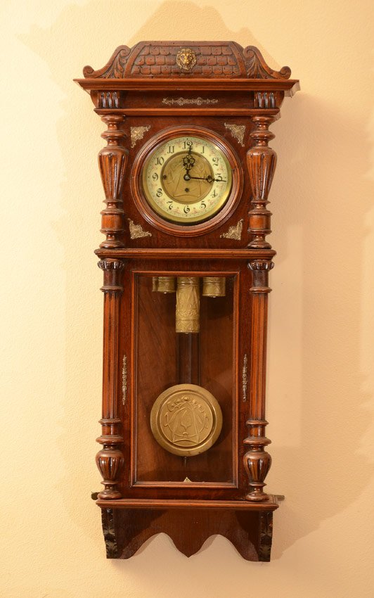 GUSTAV BECKER TRIPLE WEIGHT REGULATOR WALL CLOCK: GUSTAV BECKER TRIPLE WEIGHT REGULATOR WALL CLOCK: Removable carved crest with applied lion masqueron. Walnut case with applied carved and metal decoration. Dial with art nouveau motif embossed center,