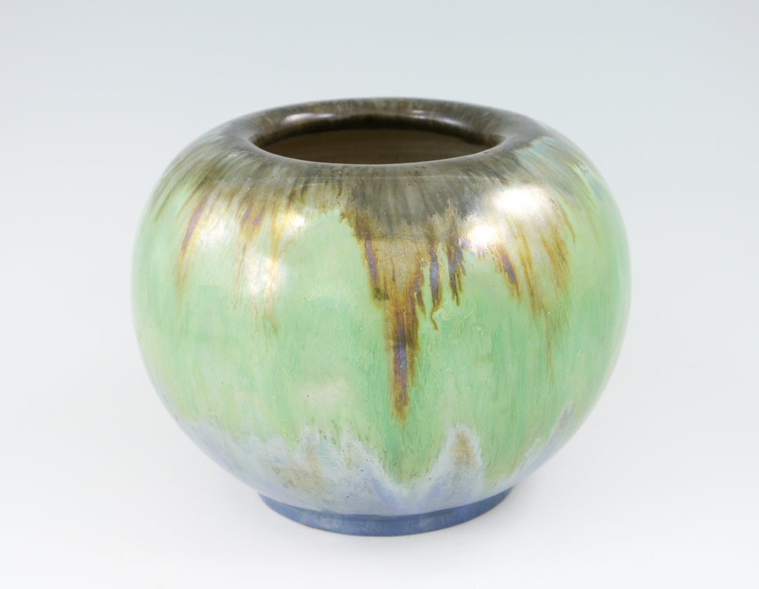FULPER GREEN POTTERY VASE: FULPER GREEN POTTERY VASE: Hues of browns around lip, blues at base, on green ground. Underglaze Fulper stamping on base. 5 1/2'' h. x 7 1/2'' dia.