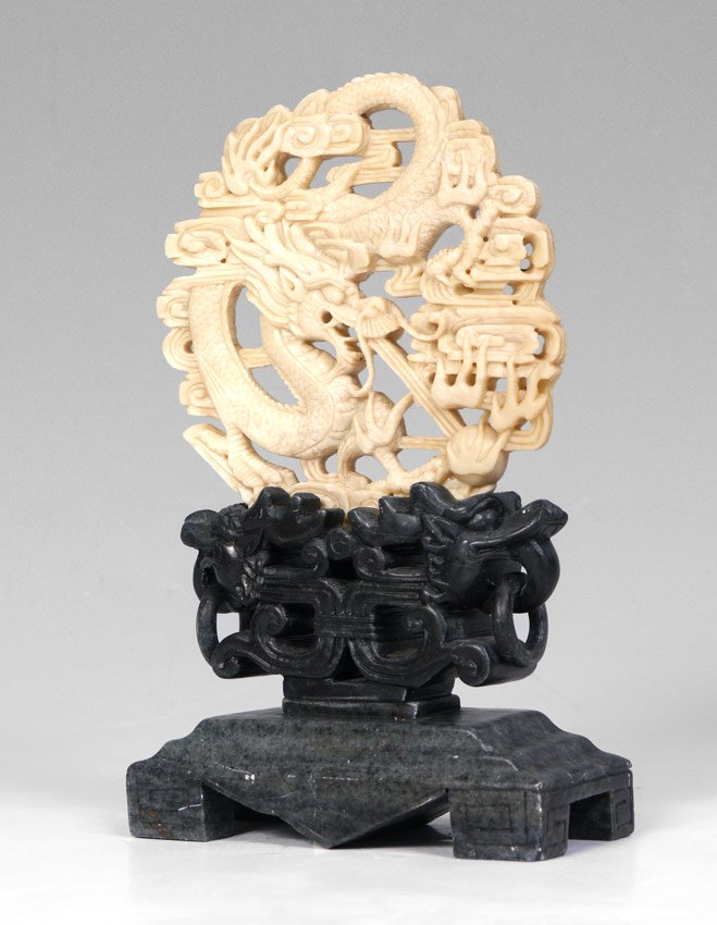 SOAPSTONE CARVED TABLE SCREEN: SOAPSTONE CARVED TABLE SCREEN: Removable white dragon motif medallion sits in a grey base with figural dragon heads. Overall 9 3/4'' h. x 6'' x 2 3/4''.