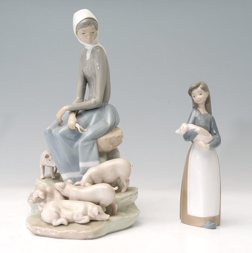 2 LLADRO PORCELAIN FIGURES Girls w/ pigs 1101 4572: 2 LLADRO PORCELAIN FIGURINES: By sculptor Fulgencio Garcia. "Girl with Piglets" #4572, issued 1969 retired 1985, 10 1/2"h. And "Girl with Pig" #1011, issued 1969 retired 2001, 6 3/4"h. Sold as a lot.