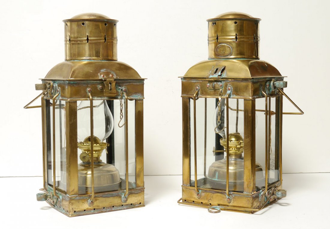 PAIR NEPTUNE BRASS SHIPS LANTERNS: PAIR NEPTUNE BRASS SHIPS LANTERNS: Brass and copper with original oil fixtures and glass chimneys. Each measures overall 17 1/2" h. x 8 3/4" x 8 1/4".