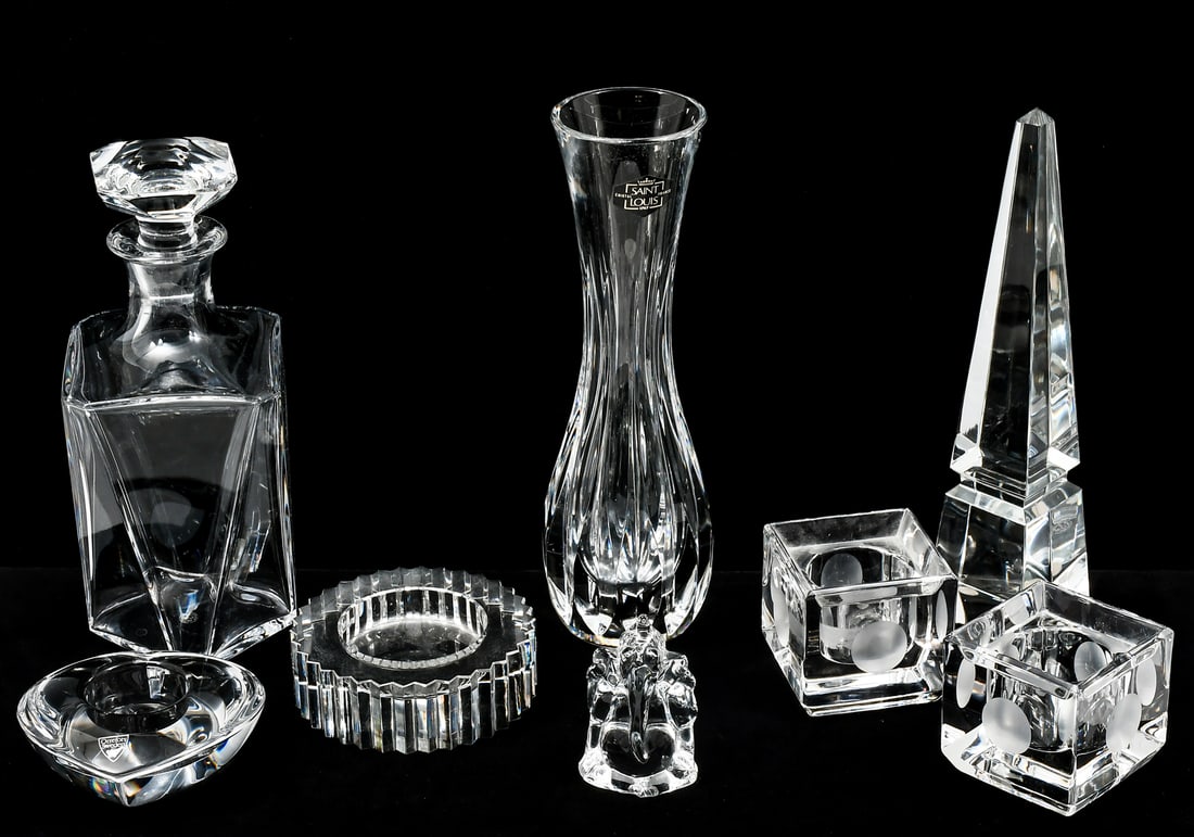 8 PC. CRYSTAL TO INCLUDE STEUBEN, BACCARAT, ETC: 8 PC. CRYSTAL TO INCLUDE STEUBEN, BACCARAT, ETC.: A collection of crystal from various makers, including paperweights, ashtrays, a decanter, and a slim vase. Largest piece being the vase, measures 9.8