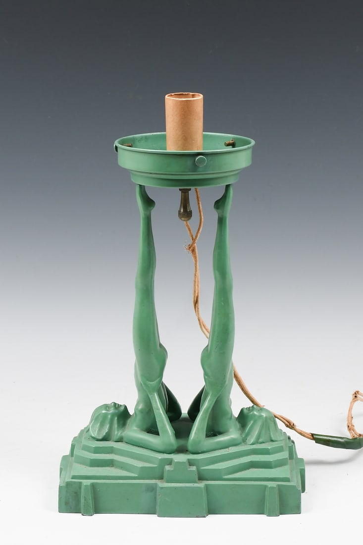ART DECO FRANKART DOUBLE NUDE LAMP: ART DECO FRANKART DOUBLE NUDE LAMP: Art Deco green enameled table lamp, model #L220, having two nude women on a stepped base, impressed "Frankart 1928. Approx. 13" h x 8" w x 5" d.