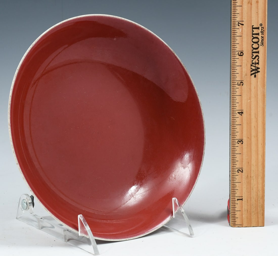 CHINESE MONOCHROME RED PORCELAIN PLATE: CHINESE MONOCHROME RED PORCELAIN PLATE: Red Ground Chinese Porcelain dish with a faint blue glaze at the underside, over a Blue Jiaqing reign (1796-1820) mark. Approx. 1.75" h x 7.5" dia.
