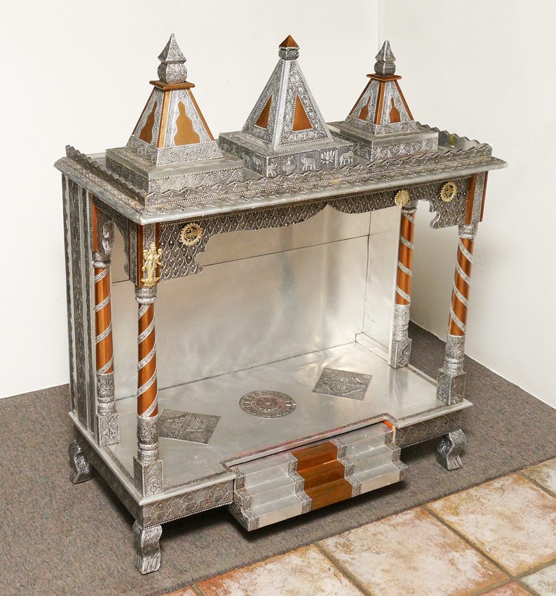 METAL CLAD BUDDHIST ALTAR: METAL CLAD BUDDHIST ALTAR: 20th Century altar clad in mixed metal, embossed tin, copper, and brass embellishments. 3 pyramid finials, shaped gallery, full and half column supports, lower shelf with st