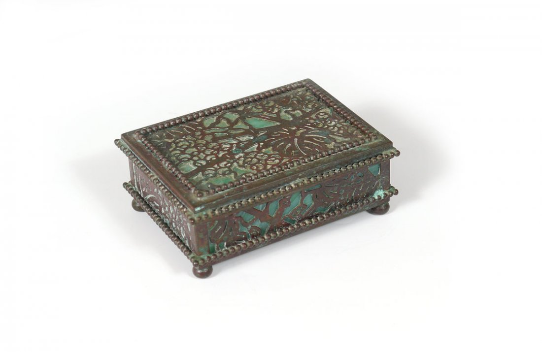 TIFFANY STUDIOS GRAPEVINE BOX 800: TIFFANY STUDIOS GRAPEVINE BOX: Green glass under bronze grapevine pattern. Impressed ''Tiffany Studios New York 800''. 1.5''h. x 4.25'' x 3.5''h.