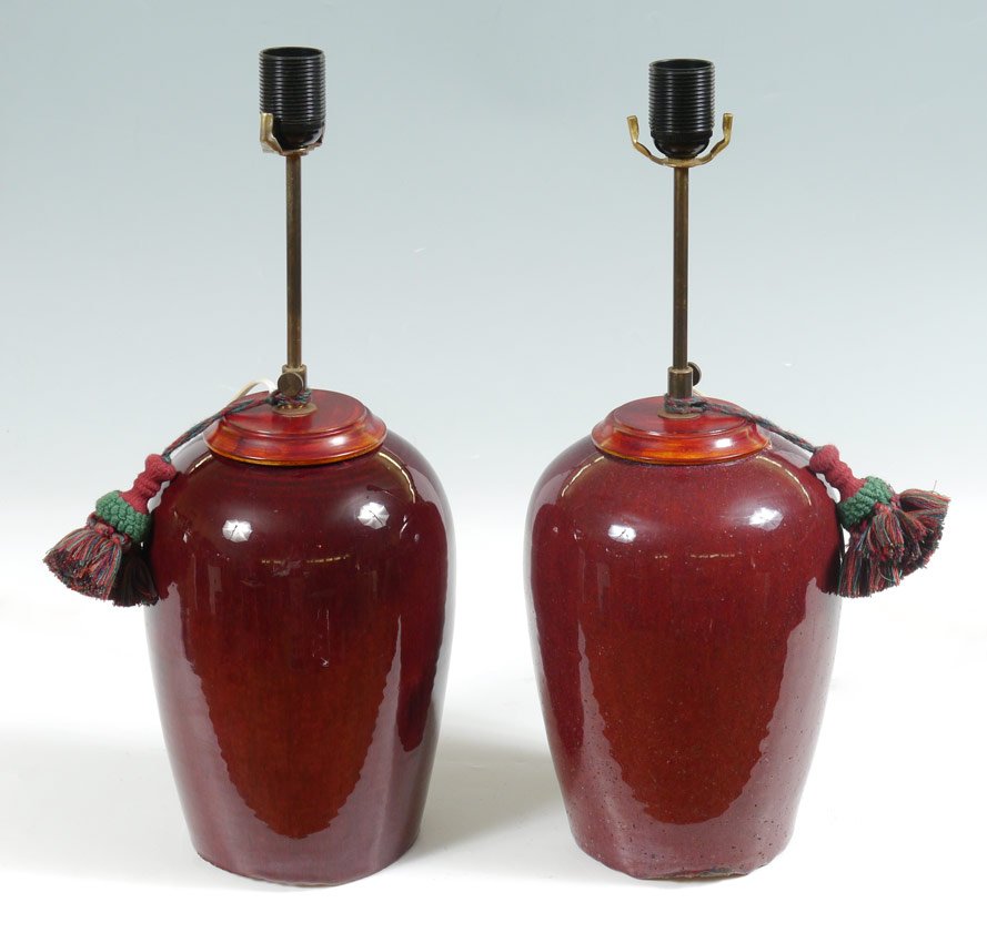 PR OXBLOOD EARTHENWARE CHINESE LAMPS: PR OXBLOOD EARTHENWARE CHINESE LAMPS: Earthenware bases with oxblood speckled glaze. Wood top, single light fixture. Remnants of red wax seal on base of one. Bases 11" h., overall 20 1/2" h. x 8". Age