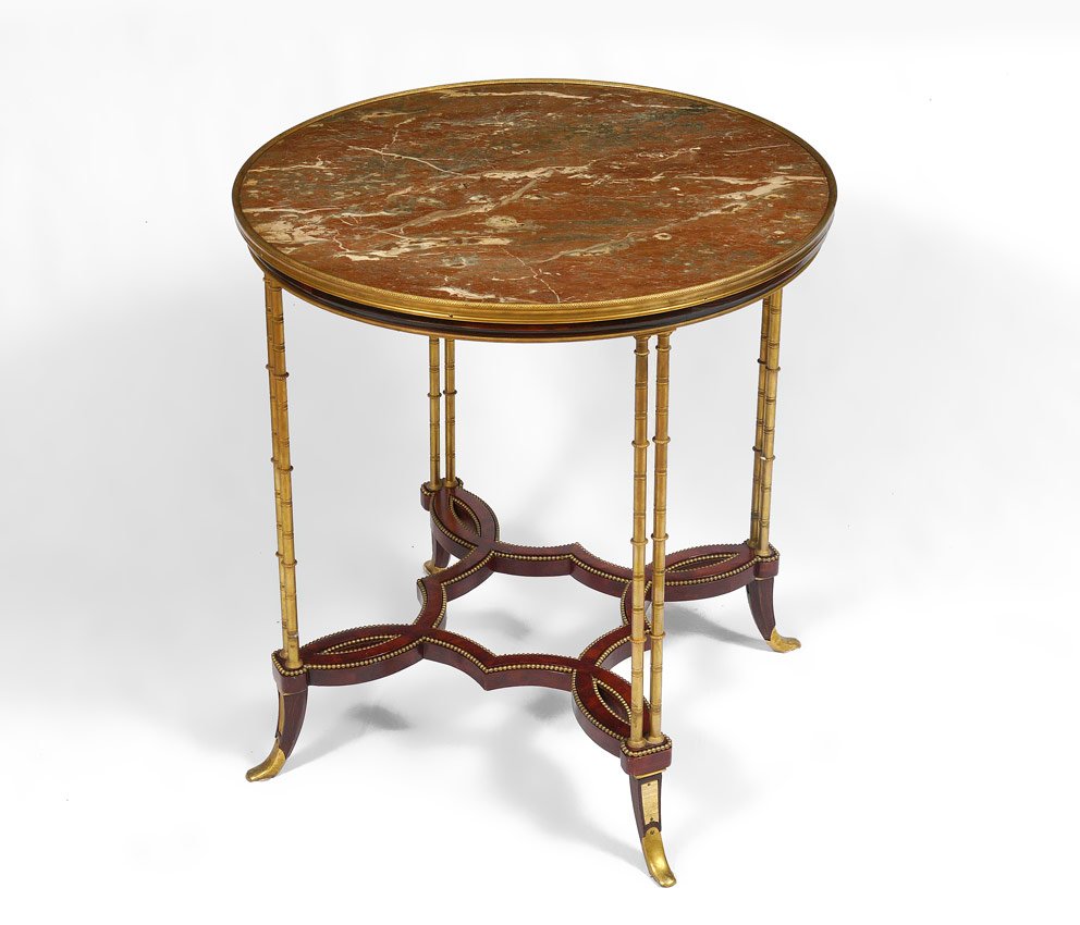 MARBLE TOP CIRCULAR SIDE TABLE: MARBLE TOP CIRCULAR SIDE TABLE: Inset marble top with brass column supports. Shaped stretchers with central finial, brass feet. 29 3/4" h. x 31 1/2" diameter.