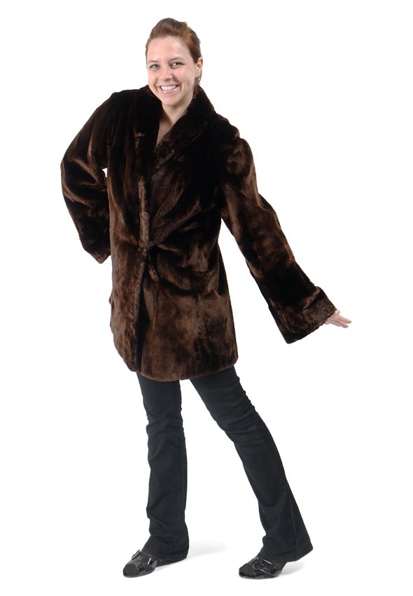 ALASKAN SEAL FUR CAR COAT: ALASKAN SEAL JACKET: Swing car coat length with full bell sleeves. Label from A.E. Burkhardt Co, Cincinnati, OH. Measures approx. 33" collar to hem, 24" shoulder to cuff and 18" shoulder to shoulder.