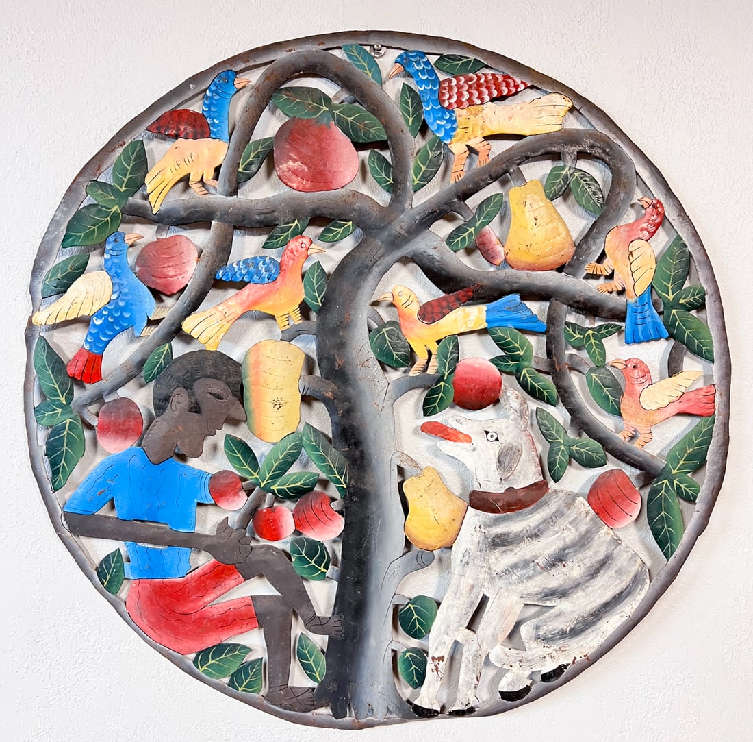 HAITIAN PAINTED STEEL FOLK ART: HAITIAN PAINTED STEEL FOLK ART: Signed J.N. Etheard. Depicts a man picking fruit with birds and his dog. Approximately 33” in diameter.