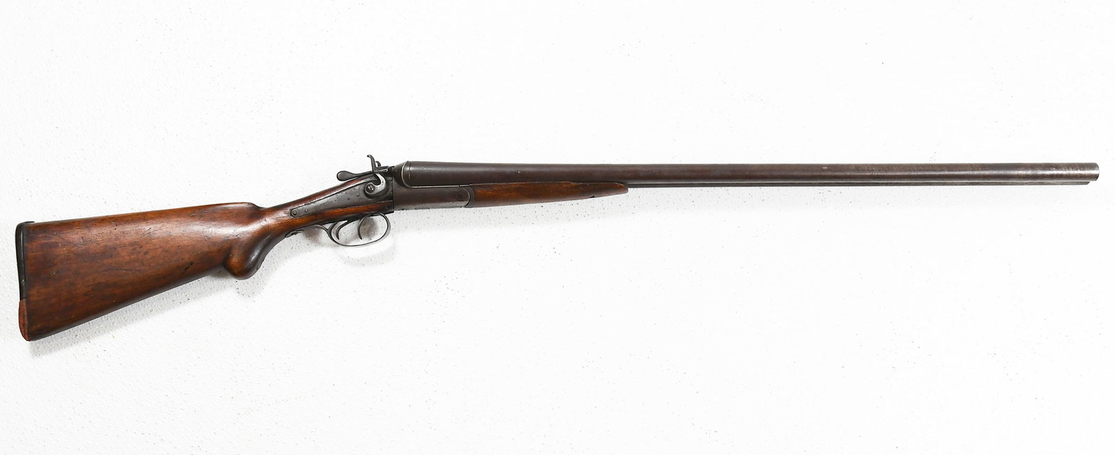 NEUMANN BROS. 12 GAUGE DOUBLE BARREL SHOTGUN: NEUMANN BROS. 12 GAUGE DOUBLE BARREL SHOTGUN: Classic double-barrel shotgun with wooden stock. Stamped "Neumann Bros." on the action. Measures 46.75" in length.