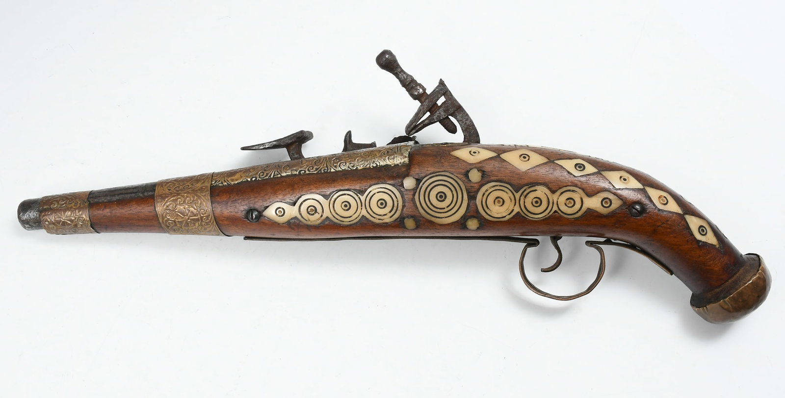 18/19TH C. INLAID FLINTLOCK PERCUSSION PISTOL: 18/19TH C. INLAID FLINTLOCK PERCUSSION PISTOL: Historical flintlock pistol with inlays in circular and diamond patterns. Measures 17" in length.