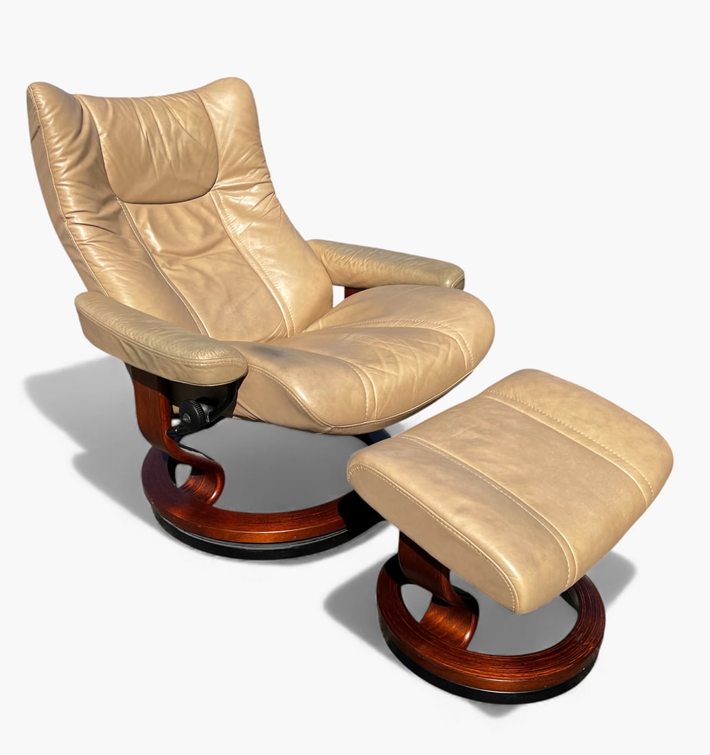 EKORNES STRESSLESS LEATHER CHAIR & OTTOMAN: EKORNES STRESSLESS LEATHER CHAIR & OTTOMAN: Tan leather upholstery with wood bases. Marked Stressless Ekornes on knobs. Chair Approx. 42" h x 33" w x 30" d. Ottoman Approx. 17.25" h x 21.75" w x 17" d