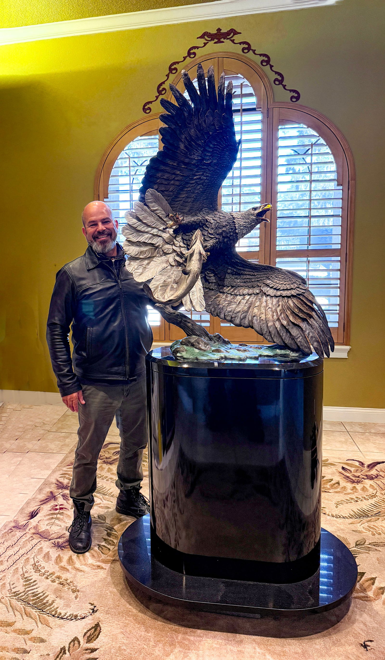 MASSIVE LIFESIZE KITTY CANTRELL BALD EAGLE BRONZE: CANTRELL, Kitty, (American, b. 1956): “Windwalker”, Bald Eagle with Trout, Patinated Bronze, approximately 51” in height, signed, Legends foundry stamp, numbered 14/150. Affixed to a cus