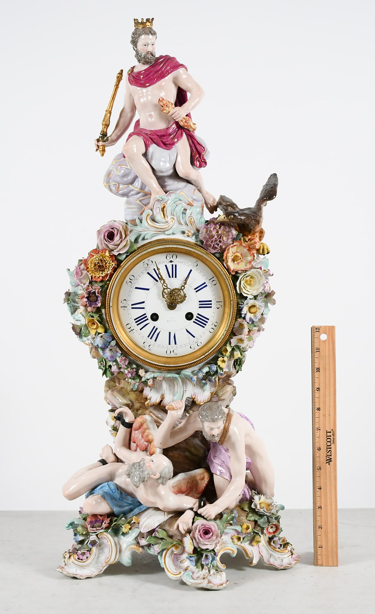 MEISSEN STYLE PORCELAIN FIGURAL CLOCK: MEISSEN STYLE PORCELAIN FIGURAL CLOCK: Meissen porcelain "Shackled Prometheus" clock depicting Zeus seated atop with a scepter. while Prometheus is shackled to the ground. Henry Marc, Paris movement. 