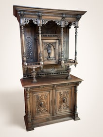 FIGURAL CARVED STEPBACK CUPBOARD