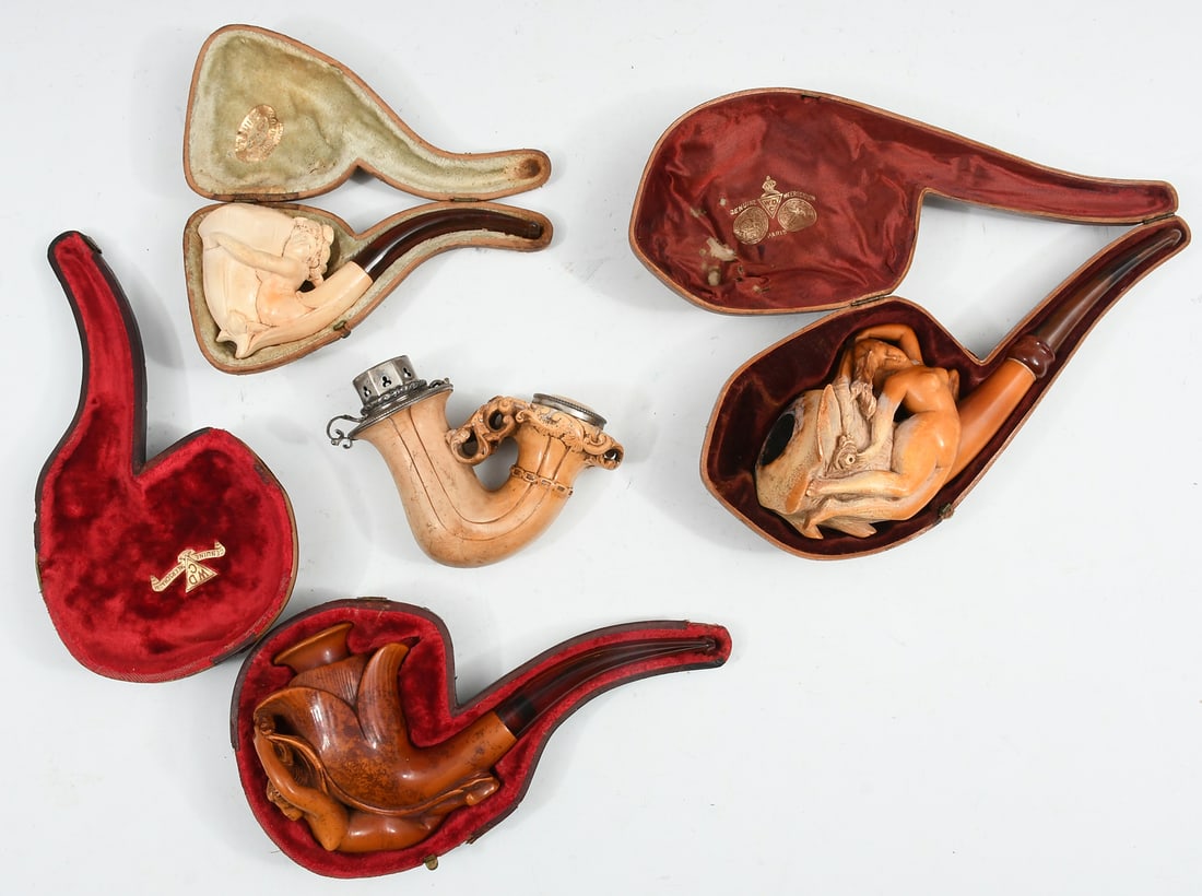 4 PC. CARVED ANTIQUE MEERSCHAUM PIPES: 4 PC. CARVED ANTIQUE MEERSCHAUM PIPES: Comprising; 1- Jon H. Menhard pipe, having a pierced foliate motif with a figure in center, enjoying a libation. 1- Floriform pipe with a Nude Female, resting in