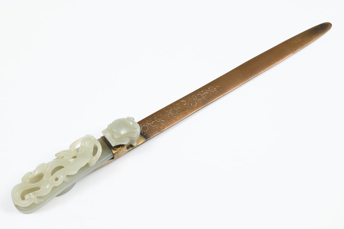 CHINESE CELADON JADE DRAGON HANDLED LETTER OPENER: CHINESE CELADON JADE DRAGON HANDLED LETTER OPENER: A nicely carved Celadon Jade Dragon Belt Buckle that was re purposed as a Letter Opener. Jade handle is a reticulated Dragon. Brass blade has an inci