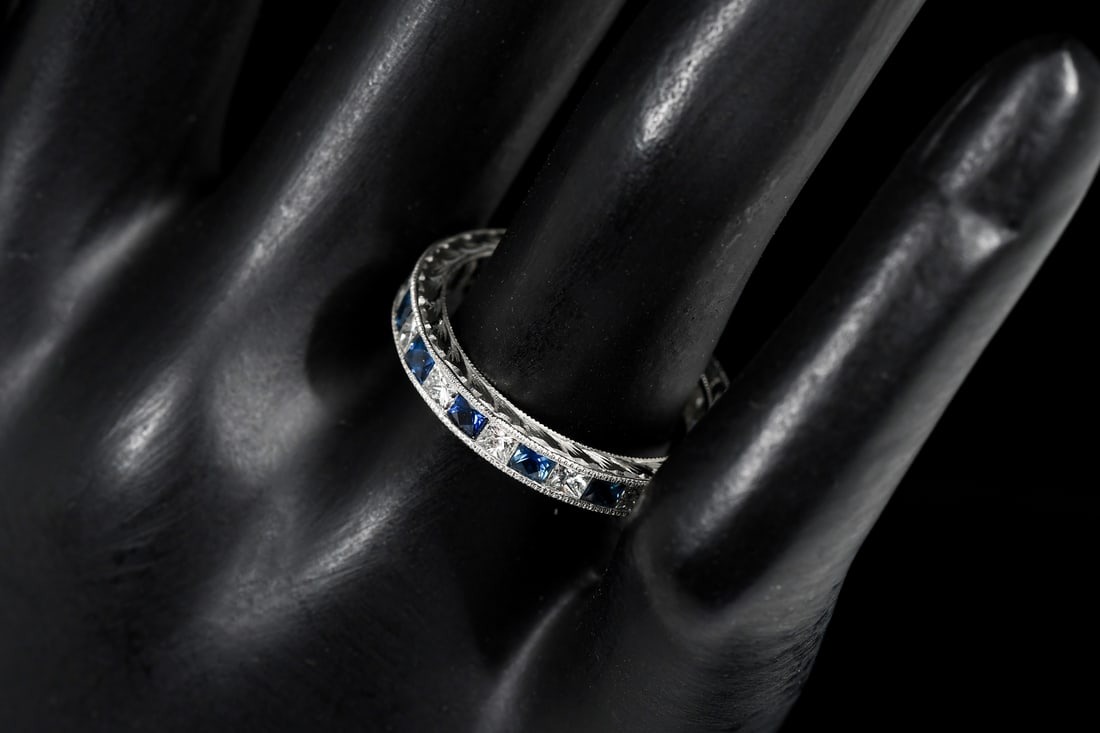 PLATINUM DIAMOND & SAPPHIRE ETERNITY RING: PLATINUM DIAMOND & SAPPHIRE ETERNITY RING: Platinum diamond and sapphire ring contains 14 square brilliant cut diamonds. Total Diamond Weight: 1.17 Ct. Approx. rated VS in clarity and F-G in color. 14