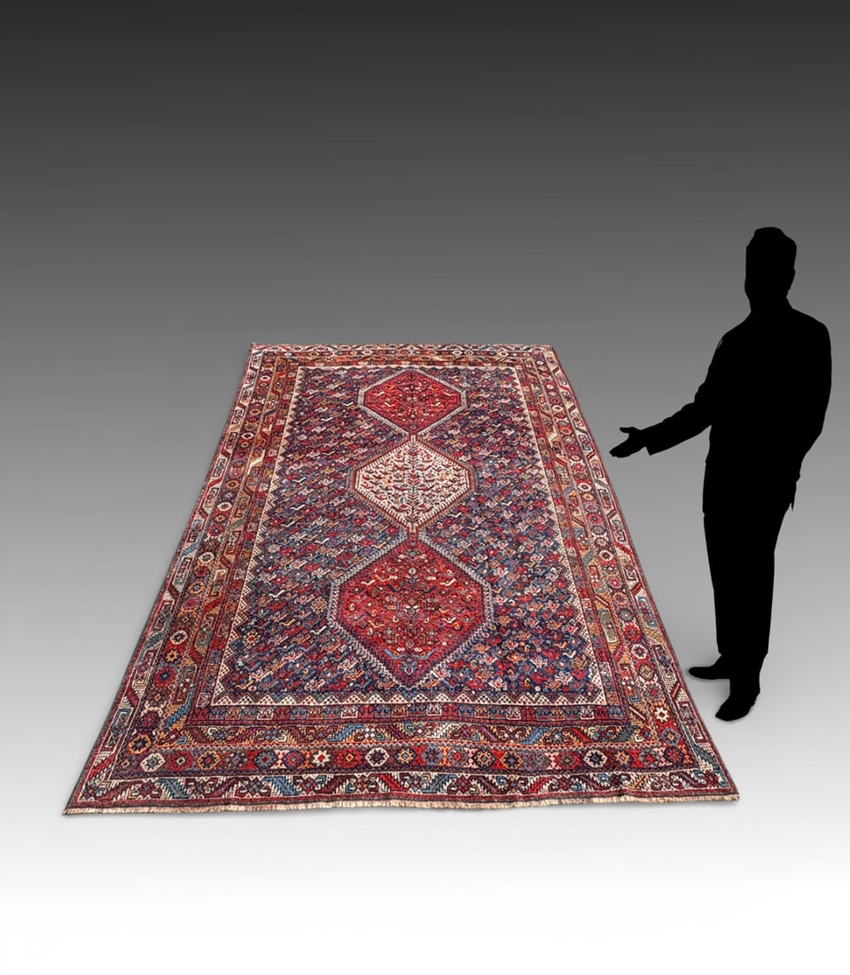 ANTIQUE CAUCASIAN SHIRVAN DESIGN WOOL RUG: ANTIQUE CAUCASIAN SHIRVAN DESIGN WOOL RUG: Centered by three boldly drawn hooked medallions on a densely patterned indigo field. The rug is energized by angular latch-hook motifs and framed by a stron