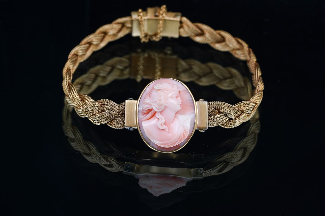 14K GOLD VICTORIAN ETRUSCAN CORAL CAMEO BRACELET: 14K GOLD VICTORIAN ETRUSCAN CORAL CAMEO BRACELET: 14K yellow gold Victorian Etruscan revival coral cameo bracelet. Braided mesh with 22.00 x 17.00 mm carved coral cameo center. Decorative clasp with s