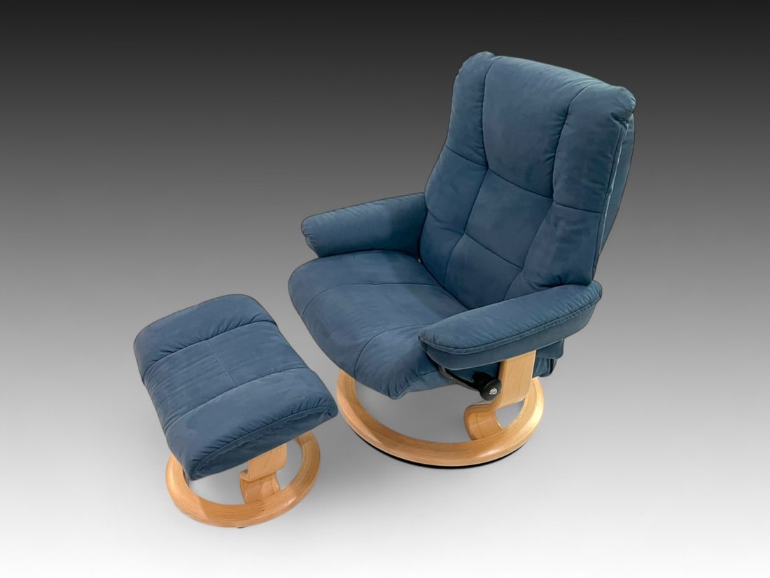 2 PC. EKORNES STRESSLESS LOUNGE CHAIR & OTTOMAN: 2 PC. EKORNES STRESSLESS LOUNGE CHAIR & OTTOMAN: A set of Blue Suede upholstered Stressless Lounge Chair & Ottoman. Both with Blonde wood bases. Chair approx. 40.75" h x 34.75" w x 29" d. Ottoman appr