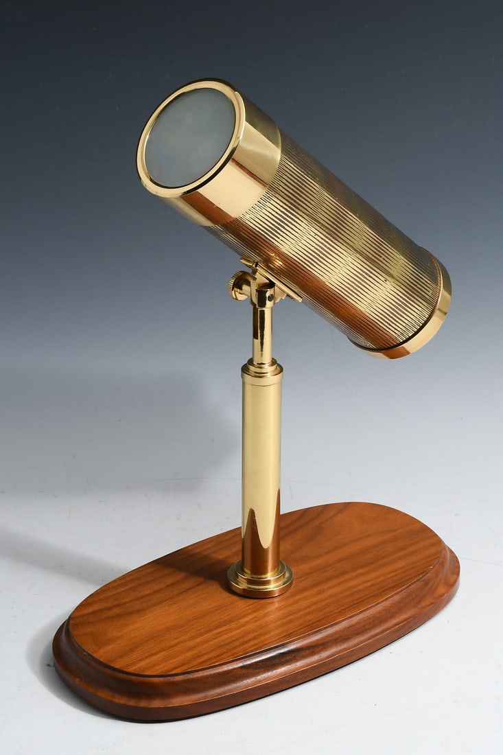 TOM RAREDON AMERICAN PARLOR KALEIDOSCOPE ON STAND: TOM RAREDON AMERICAN PARLOR KALEIDOSCOPE ON STAND: Metal kaleidoscope on oval wooden stand by Tom Raredon Metalwork. From the American Parlor Kaleidoscope Series II, number 199/350. Kaleidoscope measu