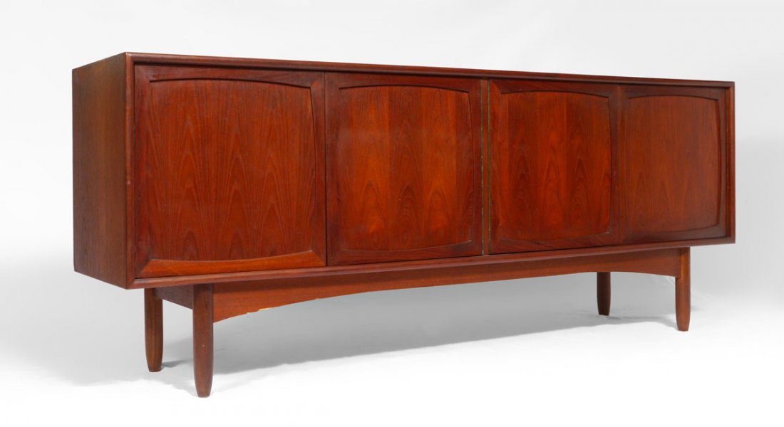 MID CENTURY TEAK CREDENZA: MID CENTURY TEAK CREDENZA: 4 doors with 2 internal drawer on 4 legs. Classic mid century design, unmarked as to maker. 29'' h. x 72'' x 16 3/4''.