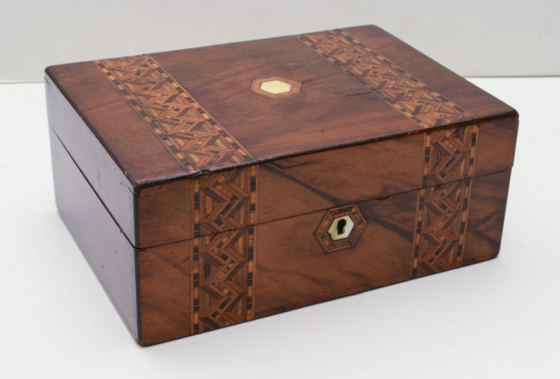 19TH CENTURY ENGLISH PARQUETRY INLAY BOX: 19TH CENTURY ENGLISH PARQUETRY INLAY BOX: Rosewood veneer with geometric parquetry inlay bands, inset ivory inlay on hinged lid. Mother of pearl inlay escutcheon. Vibrant patterned interior. Measures 