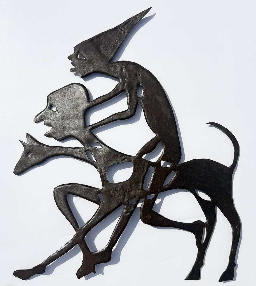 MURAT BRIERE HAITIAN METAL ARTWORK: BRIERE, Murat, (Haitian, 1938-1988): Stylized Amalgamation of Two Male Figures and a Hound, Painted Metal, 23" x 19", signed in the center.