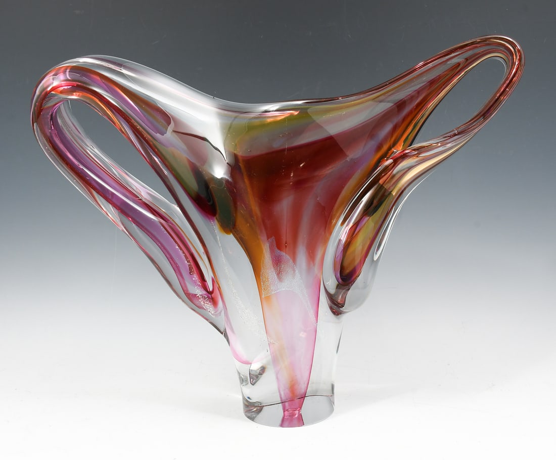 DAVID GOLDHAGEN FREEFORM ART GLASS SCULPTURE: DAVID GOLDHAGEN FREEFORM ART GLASS SCULPTURE: A Pink freeform art glass sculpture with Dichroic accents throughout, signed David Goldhagen, 02/04. Approx. 14.75" h x 18.5" w x 3.5" d.