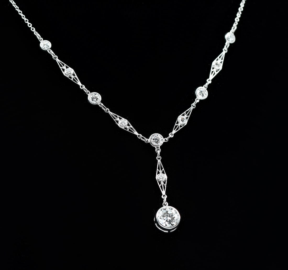 EDWARDIAN PLATINUM DIAMOND Y-CHAIN W/ NAVETTES: PLATINUM DIAMOND EDWARDIAN NECKLACE: A stunning platinum diamond Edwardian handmade drop style necklace containing 1 round brilliant cut diamond, approximately .88 Ct., 11 round brilliant cut and
