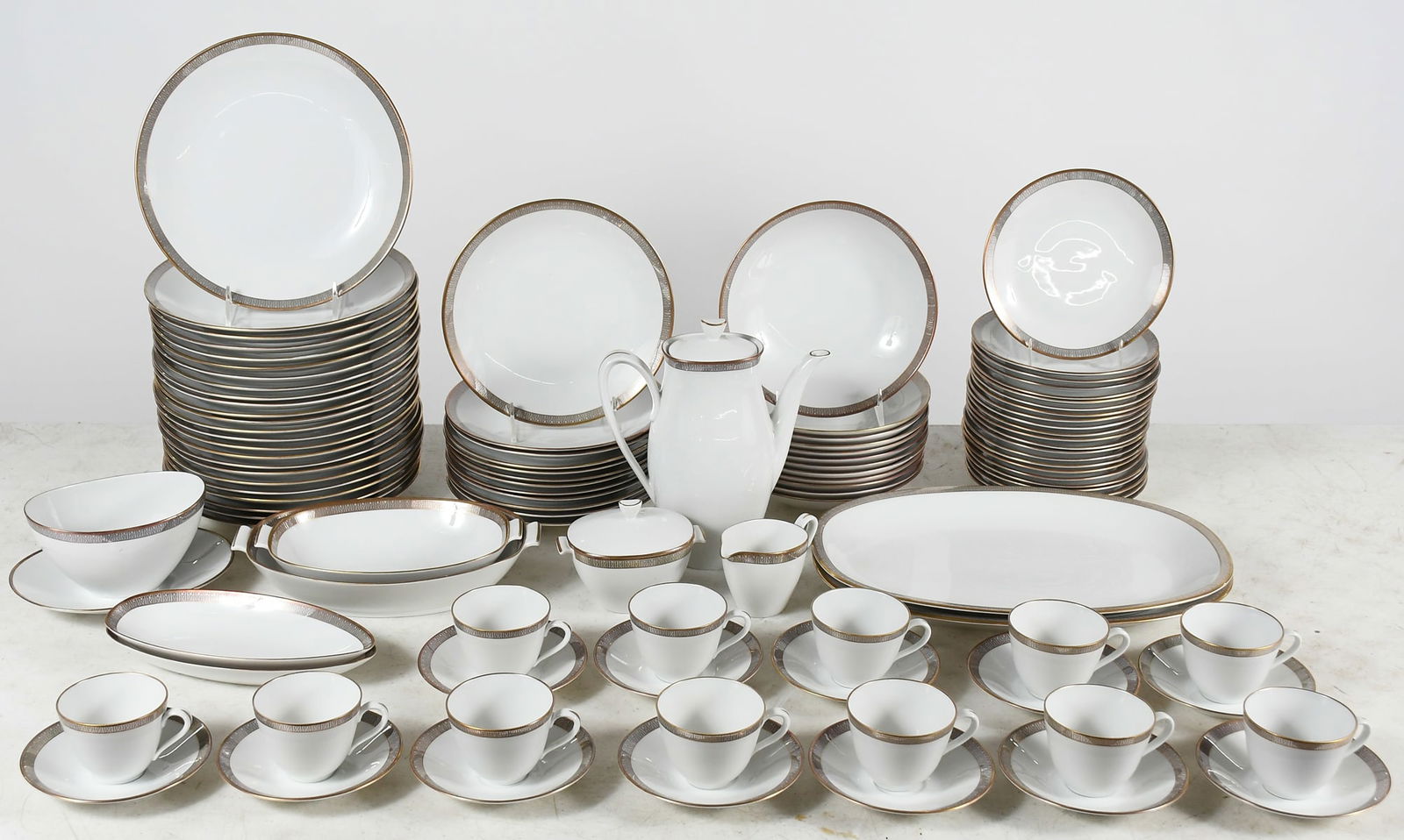 105 PC. SWEDISH RORSTRAND "EXCLUSIV" CHINA SERVICE: 105 PC. SWEDISH RORSTRAND "EXCLUSIV" CHINA SERVICE: 1959-1971, Having a Grey ribbon and polished Gold lace, Gold trim. Pattern ROR621. Comprising; 24- Dinner Plates, 12- Luncheon Plates, 12- Soup Bowl