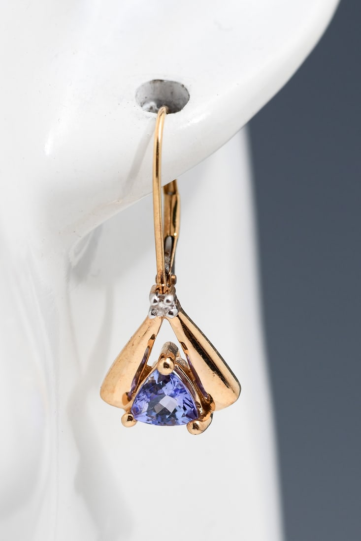 14K GOLD TANZANITE & DIAMOND EARRINGS BY LEVIAN: 14K GOLD TANZANITE & DIAMOND EARRINGS BY LEVIAN: 14K yellow gold earrings contain two triangle mixed cut tanzanite. Weight: 1.00 Ct. Approx. Two round brilliant cut diamonds. Weight: .03 Ct. Approx. R