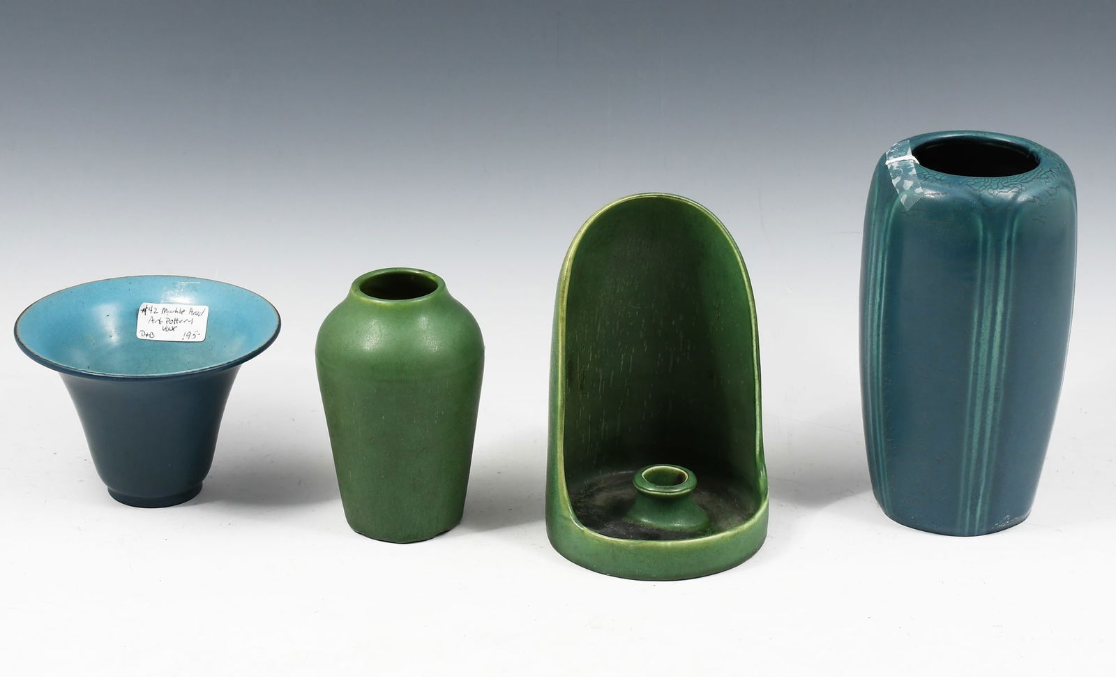 4 PC. EARLY 20TH-C. HAMPSHIRE & MARBLEHEAD POTTERY: 4 PC. EARLY 20TH-C. HAMPSHIRE & MARBLEHEAD POTTERY: Comprising a wide-rimmed blue bowl, a tall blue vase, a green vase, and an odd green handled vessel. Largest being the blue vase at 7.5" in height.