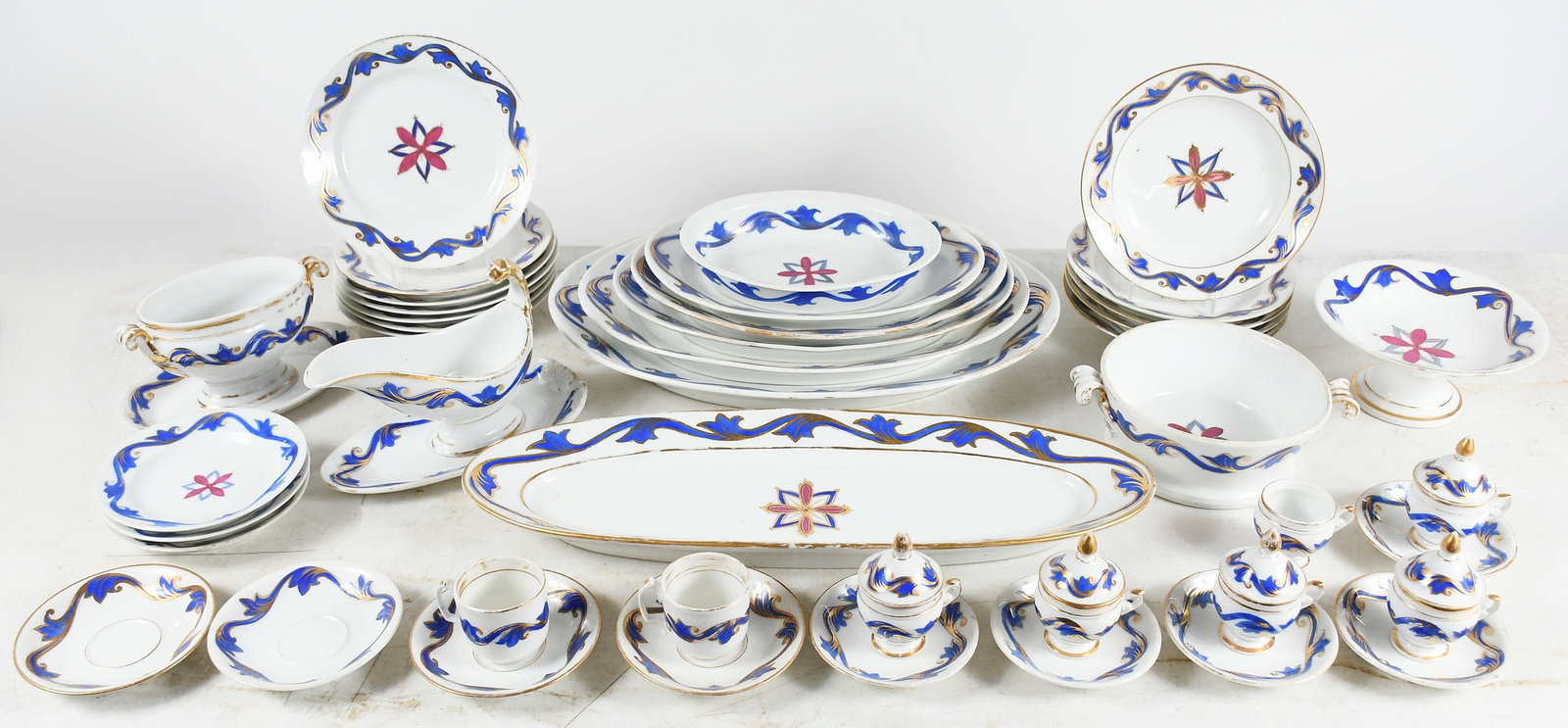EARLY 45 PC. SET OF HUNGARIAN DISHES/DINNERWARE: EARLY 45 PC. SET OF HUNGARIAN DISHES/DINNERWARE: White with rich blue gilt-trimmed patterned edges and center medallions. Comprising: 7- Dinner plates; 5- Dinner bowls; 3- Bread plates; 7- Serving pla