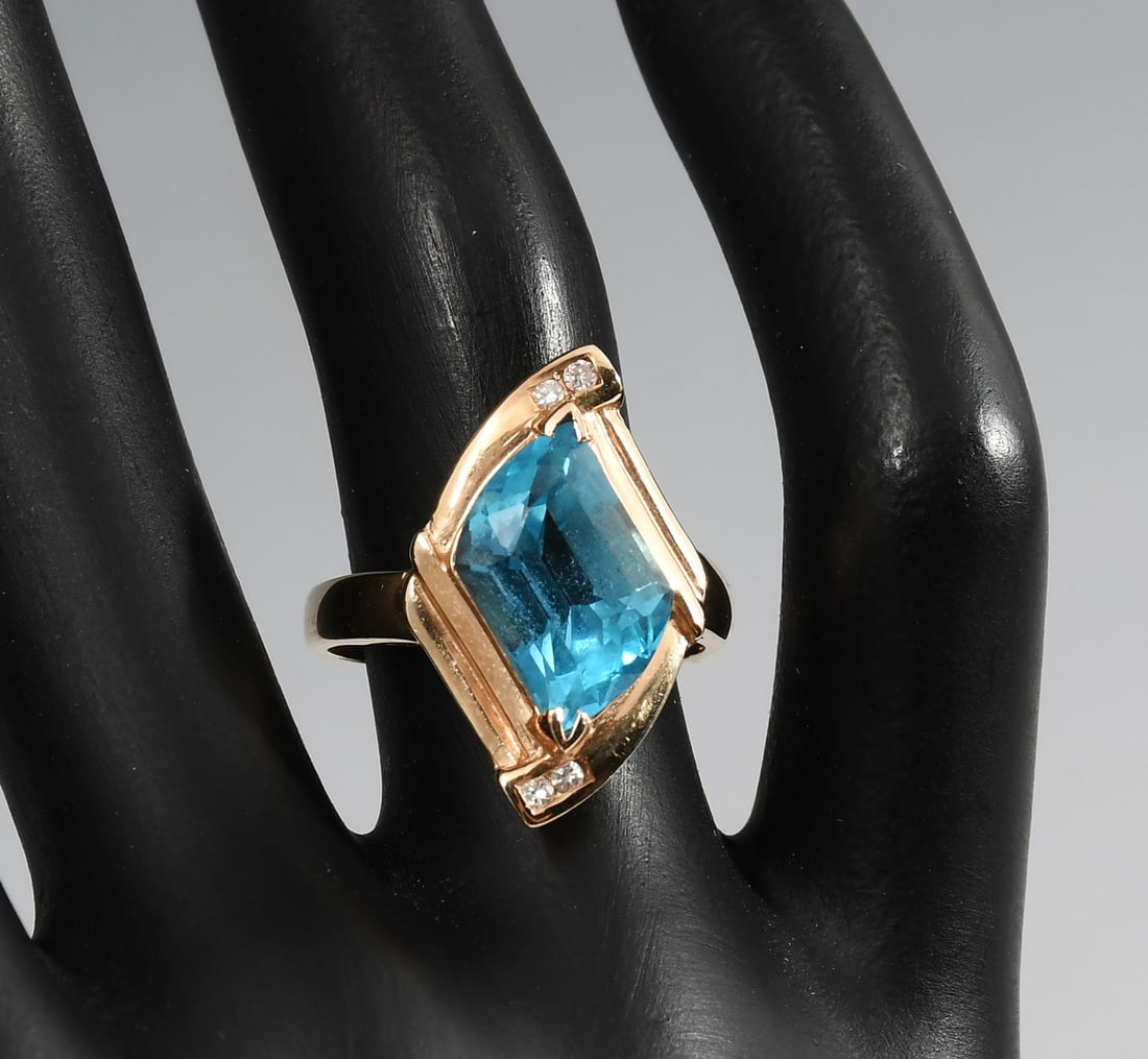 14K BLUE TOPAZ & DIAMOND RING: 14K BLUE TOPAZ & DIAMOND RING: 14 karat yellow gold blue topaz and diamond ring. Topaz is fantasy cut, 5.0 carats. 4 round full cut diamonds @ 0.06 CTW. Rated J-K in color and I-1 in clarity. Total we