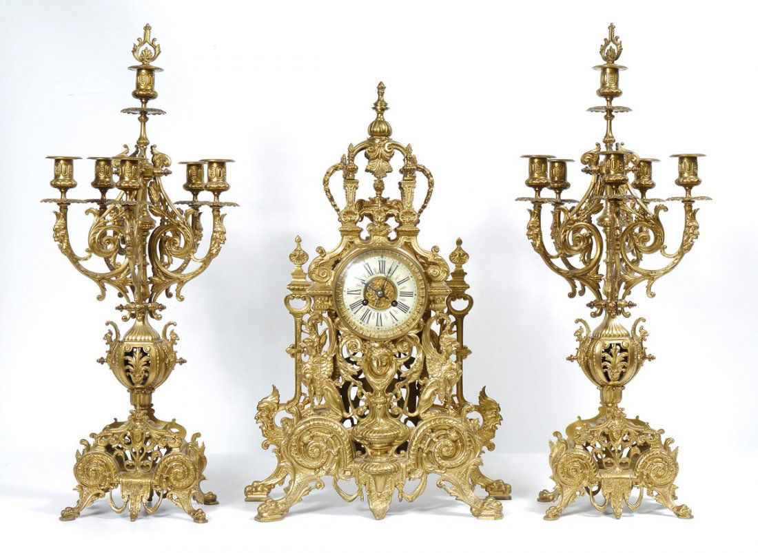TIFFANY LOUIS XIV STYLE BRONZE CLOCK GARNITURE: TIFFANY & CO. LOUIS XIV STYLE GILT BRONZE CLOCK GARNITURE SET: A fantastic clock garniture set by Tiffany & Co. to include gilt bronze mantle clock with applied decoration to include urn, griffon, Bac